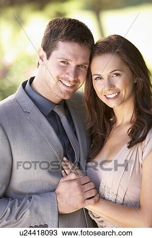 Stock Image - Smartly Dressed Young couple in park. Fotosearch