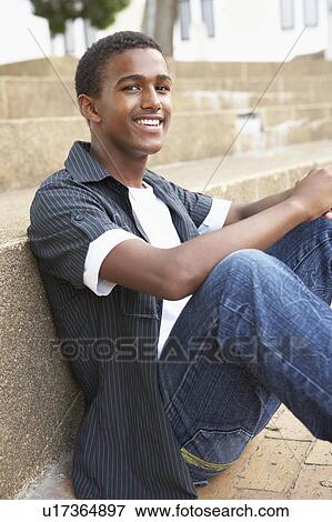 Smiling Male Teenage Student Sitting Outside On College Steps View Large Photo Image Stock Photo - Smiling Male Teenage Student Sitting Outside On College Steps. Fotosearch