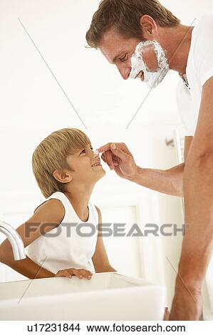 Picture - Son Watching Father Shaving In Bathroom Mirror. Fotosearch