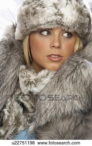 Studio Portrait Of Young Woman Wearing Fur Hat And Coat View Large Photo Image Stock Photo - Studio Portrait Of Young Woman Wearing Fur Hat And Coat. Fotosearch