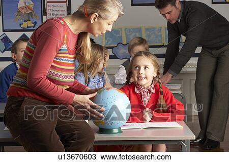Teachers Giving Geography Lesson To Primary School Children In Classroom View Large Photo Image Stock Image - Teachers Giving Geography Lesson To Primary School Children In Classroom. Fotosearch