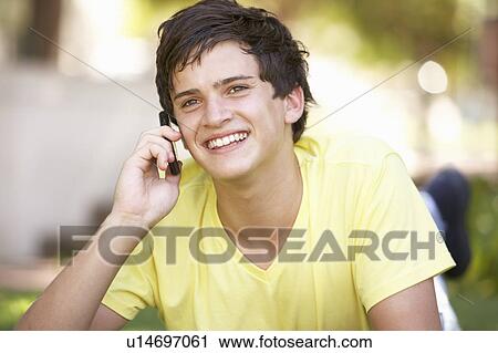 Teenage Boy Laying In Park Using Mobile Phone View Large Photo Image Stock Image - Teenage Boy Laying In Park Using Mobile Phone. Fotosearch