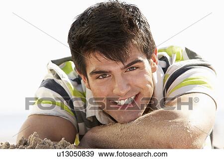 Teenage Boy Sitting On Beach View Large Photo Image Stock Photo - Teenage Boy Sitting On Beach. Fotosearch