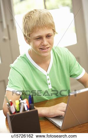 Teenage Boy Using Laptop At Home View Large Photo Image Stock Image - Teenage Boy Using Laptop At Home. Fotosearch