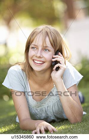 Teenage Girl Laying In Park Using Mobile Phone View Large Photo Image Stock Image - Teenage Girl Laying In Park Using Mobile Phone. Fotosearch