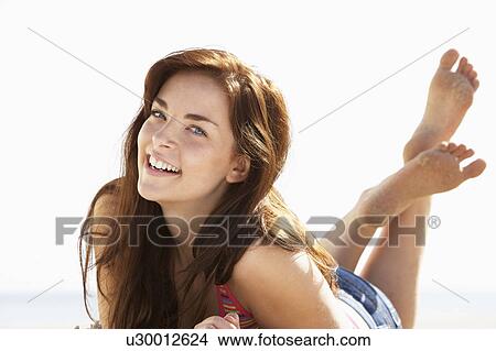 Picture - Teenage Girl Relaxing On Beach. Fotosearch