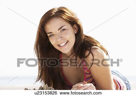 Stock Photograph - Teenage Girl Relaxing On Beach. Fotosearch