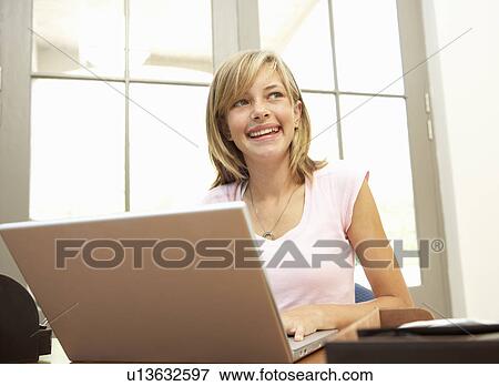 Stock Photo - Teenage Girl Using Laptop At Home. Fotosearch