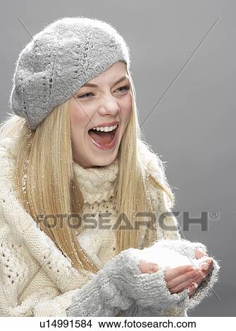Teenage Girl Wearing Warm Winter Clothes And Hat Blowing Snow In Studio View Large Photo Image Picture - Teenage Girl Wearing Warm Winter Clothes And Hat Blowing Snow In Studio. Fotosearch