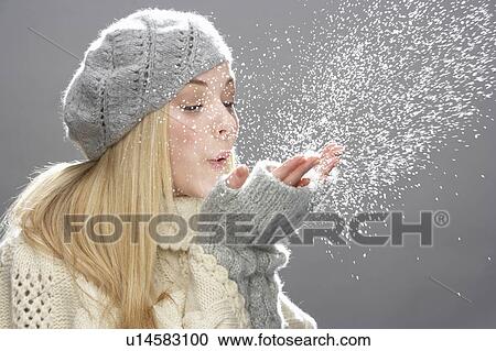 Teenage Girl Wearing Warm Winter Clothes And Hat Blowing Snow In Studio View Large Photo Image Stock Image - Teenage Girl Wearing Warm Winter Clothes And Hat Blowing Snow In Studio. Fotosearch