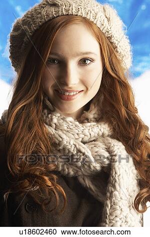 Stock Image - Teenage Girl Wearing Warm Winter Clothes And Hat In Studio. Fotosearch