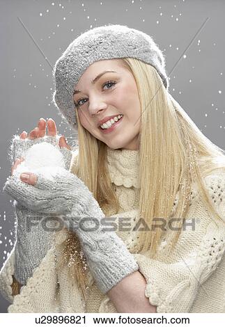 Teenage Girl Wearing Warm Winter Clothes And Hat Holding Snowball In Studio View Large Photo Image Stock Image - Teenage Girl Wearing Warm Winter Clothes And Hat Holding Snowball In Studio. Fotosearch
