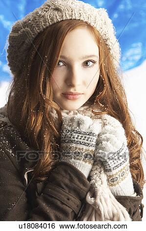 Stock Photograph - Teenage Girl Wearing Warm Winter Clothes And Hat In Studio. Fotosearch