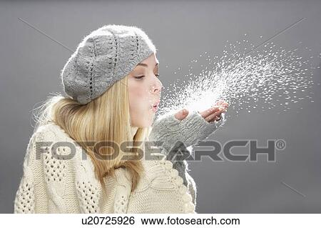 Teenage Girl Wearing Warm Winter Clothes And Hat Blowing Snow In Studio View Large Photo Image Stock Photograph - Teenage Girl Wearing Warm Winter Clothes And Hat Blowing Snow In Studio. Fotosearch