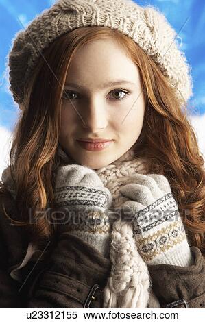 Stock Photography - Teenage Girl Wearing Warm Winter Clothes And Hat In Studio. Fotosearch