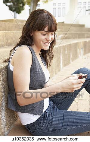 Teenage Student Sitting Outside On College Steps Using Mobile Phone View Large Photo Image Stock Photography - Teenage Student Sitting Outside On College Steps Using Mobile Phone. Fotosearch