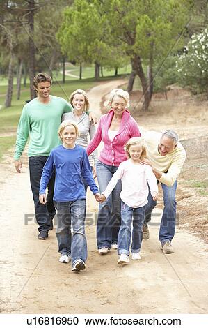 Stock Image - Three Generation Family enjoying walk in park. Fotosearch