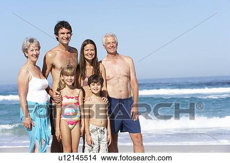 Three Generation Family On Holiday Walking Along Beach View Large Photo Image Picture - Three Generation Family On Holiday Walking Along Beach. Fotosearch