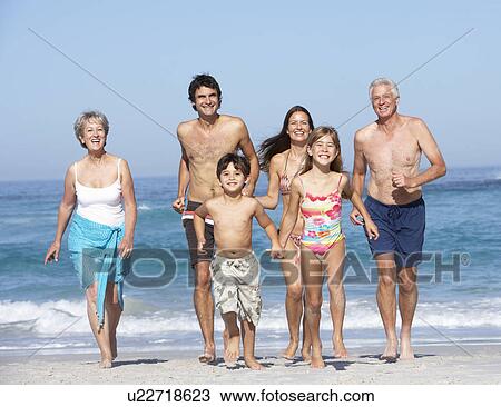 Three Generation Family On Holiday Walking Along Beach View Large Photo Image Stock Image - Three Generation Family On Holiday Walking Along Beach. Fotosearch