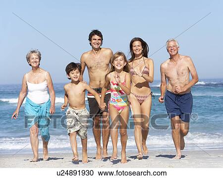 Three Generation Family On Holiday Walking Along Beach View Large Photo Image Stock Image - Three Generation Family On Holiday Walking Along Beach. Fotosearch