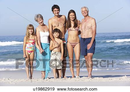 Three Generation Family On Holiday Walking Along Beach View Large Photo Image Stock Photo - Three Generation Family On Holiday Walking Along Beach. Fotosearch