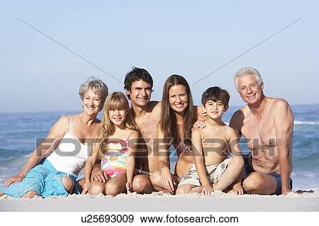 Three Generation Family On Holiday Walking Along Beach View Large Photo Image Stock Photo - Three Generation Family On Holiday Walking Along Beach. Fotosearch