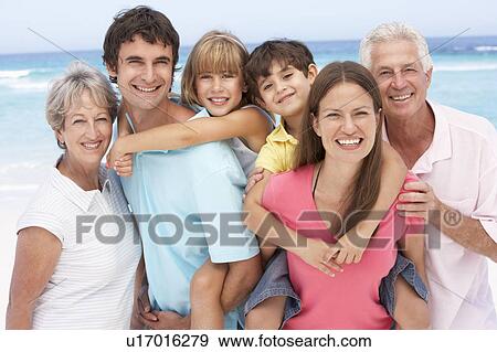 Three Generation Family Relaxing On Beach Holiday View Large Photo Image Stock Photo - Three Generation Family Relaxing On Beach Holiday. Fotosearch