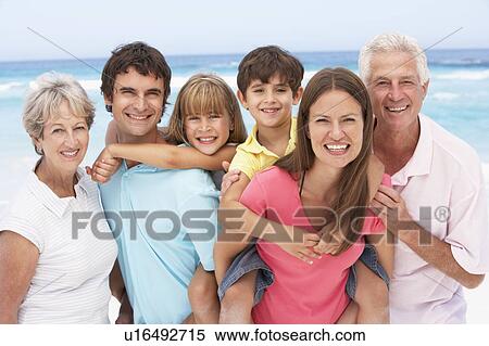 Three Generation Family Relaxing On Beach Holiday View Large Photo Image Stock Photography - Three Generation Family Relaxing On Beach Holiday. Fotosearch
