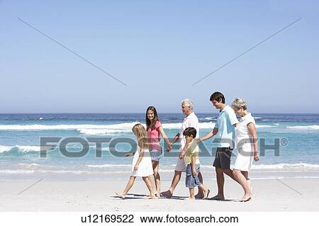 Three Generation Family Walking Along Sandy Beach View Large Photo Image Stock Image - Three Generation Family Walking Along Sandy Beach. Fotosearch