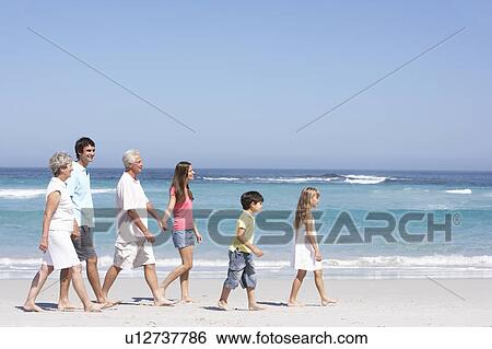 Three Generation Family Walking Along Sandy Beach View Large Photo Image Stock Photograph - Three Generation Family Walking Along Sandy Beach. Fotosearch