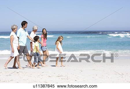 Three Generation Family Walking Along Sandy Beach View Large Photo Image Stock Photography - Three Generation Family Walking Along Sandy Beach. Fotosearch