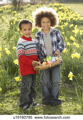 Two Boys Having Easter Egg Hunt In Daffodil Field View Large Photo Image Stock Photography - Two Boys Having Easter Egg Hunt In Daffodil Field. Fotosearch