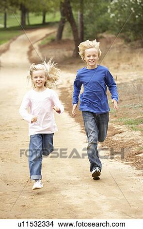 Two Children running in park View Large Photo Image Picture - Two Children running in park. Fotosearch