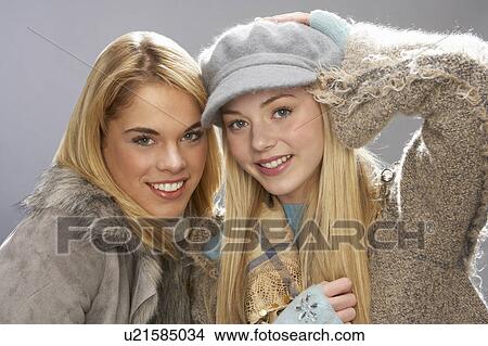 Picture - Two Fashionable Teenage Girls Wearing Cap And Knitwear In Studio. Fotosearch