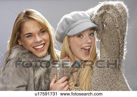Two Fashionable Teenage Girls Wearing Cap And Knitwear In Studio View Large Photo Image Stock Image - Two Fashionable Teenage Girls Wearing Cap And Knitwear In Studio. Fotosearch
