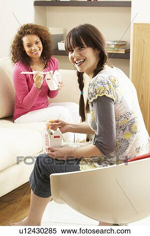 Two Female Friends Enjoying Chinese Takeaway Meal At Home View Large Photo Image Stock Photography - Two Female Friends Enjoying Chinese Takeaway Meal At Home. Fotosearch