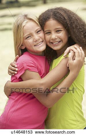 Two Girls In Park Giving Each Other Hug View Large Photo Image Stock Image - Two Girls In Park Giving Each Other Hug. Fotosearch