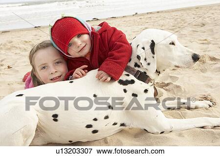 Two Girls On Beach With Pet Dog View Large Photo Image Stock Photo - Two Girls On Beach With Pet Dog. Fotosearch