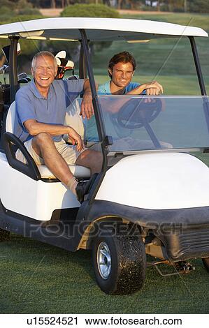Two Male Golfers Riding In Golf Buggy On Golf Course View Large Photo Image Stock Image - Two Male Golfers Riding In Golf Buggy On Golf Course. Fotosearch