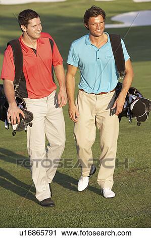 Two Men Walking Along Golf Course Carrying Bags View Large Photo Image Stock Image - Two Men Walking Along Golf Course Carrying Bags. Fotosearch