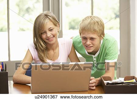 Two Teenagers Using Laptop At Home View Large Photo Image Stock Photo - Two Teenagers Using Laptop At Home. Fotosearch