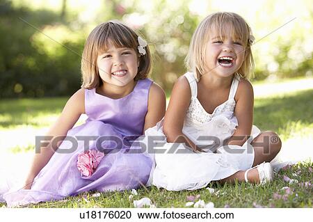 Stock Image - Two young girls posing in park. Fotosearch