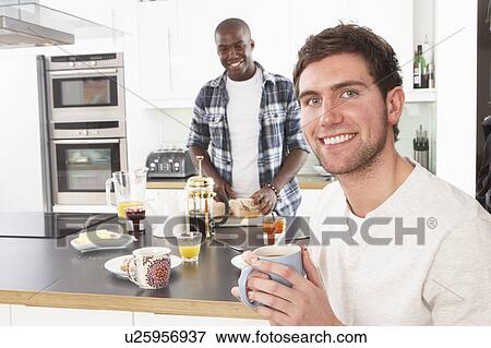 Two Young Men Preparing Breakfast In Modern Kitchen View Large Photo Image Stock Photo - Two Young Men Preparing Breakfast In Modern Kitchen. Fotosearch