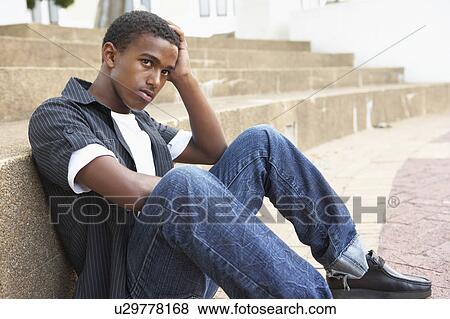Unhappy Male Teenage Student Sitting Outside On College Steps View Large Photo Image Stock Photo - Unhappy Male Teenage Student Sitting Outside On College Steps. Fotosearch