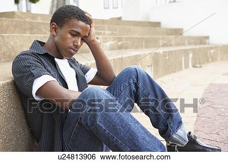 Unhappy Male Teenage Student Sitting Outside On College Steps View Large Photo Image Stock Photograph - Unhappy Male Teenage Student Sitting Outside On College Steps. Fotosearch