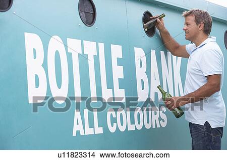 Woman At Recycling Centre Disposing Of Glass At Bottle Bank View Large Photo Image Picture - Woman At Recycling Centre Disposing Of Glass At Bottle Bank. Fotosearch