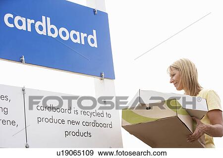 Stock Photo - Woman At Recycling Centre Disposing Of Cardboard. Fotosearch