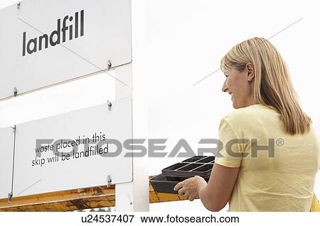 Woman At Recycling Centre Disposing Of Cardboard View Large Photo Image Stock Photo - Woman At Recycling Centre Disposing Of Cardboard. Fotosearch