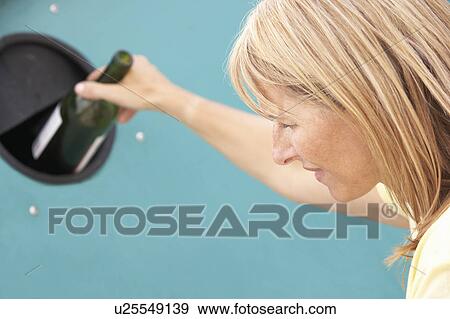 Woman At Recycling Centre Disposing Of Glass At Bottle Bank View Large Photo Image Stock Photo - Woman At Recycling Centre Disposing Of Glass At Bottle Bank. Fotosearch