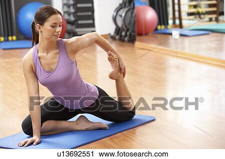 Stock Image - Woman Doing Stretching Exercises In Gym. Fotosearch